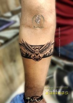 a man's arm with an owl tattoo on it