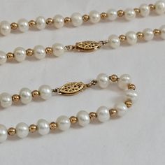 This stunning pearl and gold set features an 18" necklace and a 7.5" bracelet. Each piece is crafted with high-quality 5mm pearls and accented with 2mm 14K gold balls. The elegant design and intricate gold clasps make this set a timeless addition to any jewelry collection, perfect for weddings, anniversaries, or special occasions. Necklace length: 18 inches Bracelet length: 7.5 inches Pearl size: 5mm Gold ball size: 2mm Clasp: Delicate 14K gold filigree clasp This beautiful set comes ready to gift, making it an excellent choice for any jewelry lover. Interested in matching earrings: Here is a great set: https://www.etsy.com/listing/1780473202/14k-yellow-gold-pearl-dangle-earrings?click_key=b40a728587901a30dda69f96cc177fd7c6a5e607%3A1780473202&click_sum=b58d67bc&ref=shop_home_active_1&frs=1 Classic Single Strand Pearl Necklace In 14k Gold, Classic Gold Single Strand Pearl Necklace, Classic Gold Pearl Necklace, Classic 14k Gold Pearl Necklace, Classic Gold Pearl Necklace With Round Beads, Classic Round 14k Gold Pearl Necklace, Gold Single Strand Pearl Bracelet For Formal Occasions, Gold Akoya Pearl Single Strand Bracelet, Classic 14k Yellow Gold Pearl Necklace