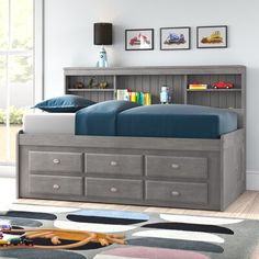 a child's bed with storage drawers underneath it