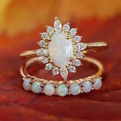 1.1CT Opal Engagement Ring Set 14K Yellow Gold Opal Wedding Ring Set Oval Cut Opal Engagement Ring Oval Wedding Ring, Gift, Anniversary Ring ❋ RING DETAIL ❋ Metal: 925 Sterling Silver (Can be made in Yellow gold & rose gold plated as well) Gemstone -: Opal  Stone Shape-: Oval  Stone Size - : 6x8 mm  Side Stone Size -: 1.50 mm Round + 1.50x3 marquise  ✥Features✥ ✥ Ready to Ship in 5-7  Business Days ✥ I accept custom making order.Please contact me if you need this service. ✥ Please Feel Free to contact us 24*7 to discuss for any order ✥ For all the jewelries,there is a 30 days money back guarantee. ✥ All items will be well packed in a beautiful ring box. ✥ If you want to upgrade your shipping speed then please add this with your product PLEASE BE ADVISED BEFORE PURCHASING: *We can not be he Luxury Yellow Gold Opal Ring With Halo Design, 14k Gold Halo Ring With Diamond Accents For Wedding, Wedding Halo Ring With Diamond Accents In 14k Gold, Gold Opal Stackable Ring With Oval Shape, Exquisite 14k Gold Oval Wedding Ring, White 14k Gold Wedding Ring, Classic Oval Cabochon Diamond Wedding Ring, Classic Pear-shaped Halo Ring For Wedding, White Oval Cluster Ring In 14k Gold