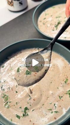 a spoon full of soup being held by someone