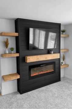 a tv mounted on top of a wooden shelf next to a fire place in a living room