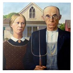 two people standing next to each other in front of a house with an odd face