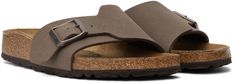 Grained Birko-Flor® faux-leather slip-on sandals in brown. · Open toe · Adjustable pin-buckle strap at vamp · Logo embossed at inner side · Logo stamp at molded suede footbed · Cork midsole · Treaded EVA rubber sole · Logo-engraved antiqued copper-tone hardware Supplier color: Mocha Classic Brown Footbed Sandals For Spring, Brown Slides With Cork-bed Midsoles For Spring, Brown Casual Slides With Adjustable Strap, Brown Slip-on Slides With Buckle Closure, Casual Brown Slides With Adjustable Strap, Birkenstock Mocha, Mocha Birkenstock, Men Birkenstock, Birkenstock Brown