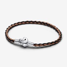 Pay tribute to a beloved film with the Disney The Lion King Clasp Pandora Moments Braided Leather Bracelet. A sterling silver clasp evokes a painting of Disney's iconic Simba character on the front and a reverse side engraving that echoes Rafiki's wise advice to "Remember who you are." For Disney lovers and dreamers, this bracelet is a symbol of the natural harmony of life and Simba's touching journey. Can be styled with up to 10 charms. - Pandora Disney The Lion King Clasp Pandora Moments Braid