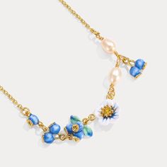 Blooming with summer sweetness, the Blueberry Flower Necklace is a captivating piece crafted in 18K gold plated brass. Each delicate petal is brought to life with vibrant enamel, capturing the essence of a blueberry blossom in its charming, rich blue hue. Made with meticulous attention to detail, the 18K gold plating and high-quality enamel ensure this necklace is a piece you'll treasure for years to come. Looking for the perfect gift for a nature lover or someone who appreciates unique and beau Blue Necklace With Flower Charm, Enamel Flower Pendant Necklace With Charm, Flower Charm Enamel Necklace, Luxury Enamel Flower Pendant Necklace, Blue Flower-shaped Jewelry With Flower Charm, Golden Necklace, Pearl Flower, Enamel Flower, Royal Jewelry