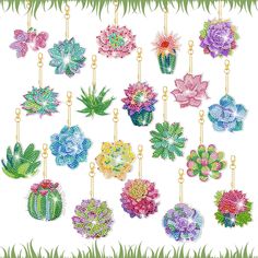 a bunch of flowers that are hanging on some chains in front of green grass and white background