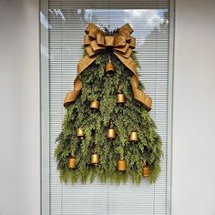 a christmas tree made out of bells and greenery