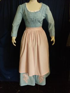 "Inspired by the live action Cinderella character. The soft, delicate dress is lightweight pale blue cotton with a gathered front panel and ruffles at the neckline. Bodice is fully lined in sturdy cotton twill. There's also a white peasant blouse insert at the neckline (not a real separate blouse). The very full skirt has six patches of pink floral appliques. It closes in back with an invisible zipper (you can choose a lace up back if you prefer). Pink apron is included. All seams are serged or Live Action Cinderella, Cinderella Characters, Delicate Dress, White Peasant Blouse, Pink Apron, 50s Dresses, Peasant Dress, Peasant Blouse, Floral Applique