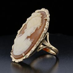 Description:This beautiful vintage Cameo Ring features a delicate hand-carved shell in an oval shape, set in 14K yellow gold. With a timeless design, this piece brings together the elegance of the past with a modern flair. A perfect addition for those who appreciate antique jewelry. Specifications: Metal: 14K Yellow Gold Weight: 5.9 grams Main Stone: Shell Main Stone Shape: Oval Main Stone Color: Orange Main Stone Size: 30x16 mm Vintage Style: Yes Item Code: 893511 Classic Oval Cameo Rings, Gold Oval Cameo Rings, Shell Carving, Classic Profile, Profile Portrait, Groom Accessories, Cameo Jewelry, Cameo Ring, Vintage Cameo