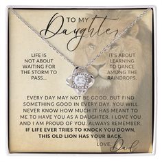 a necklace with an image of a lion and the words to my daughter on it