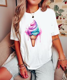 Introducing our Watercolor Ice Cream Shirt 🍦!  Embrace your sweet tooth with this vibrant and delicious design. 🍨 ✨ Made with soft, high-quality fabric, this shirt is as comfortable as it is eye-catching. 👕👌 Perfect for summer days, ice cream lovers, and anyone who wants to add a touch of sweetness to their wardrobe! 🌞🍦 Indulge in the utmost comfort and style with our BlendedApprl Unisex T-shirts. Crafted with premium quality, these tees are incredibly soft and cozy to wear. They are made from a blend of 100% cotton for solid colors and a soft cotton-polyester mix for heather colors. Rest assured, we trust BELLA+CANVAS for delivering top-notch T-shirts! FABRICATION * Direct to Garment printing methods * Solid Colors: 100% Ringspun Cotton * Heather Colors: 52% cotton, 48% polyester * Cute Tie Dye Graphic Print T-shirt, Cute Tie Dye Graphic T-shirt, Cute Tie-dye Graphic Print T-shirt, Cute Tie-dye T-shirt With Graphic Print, Cute Colorful Short Sleeve T-shirt, Sweet White T-shirt With Graphic Print, Sweet White Tops With Cartoon Print, Sweet White Short Sleeve T-shirt, White Sweet T-shirt With Funny Print