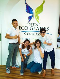 four people posing for a photo in front of a sign that says, setia eco glares cyberjayay