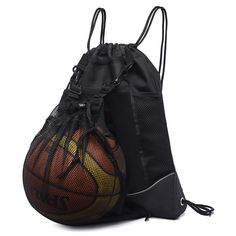 an orange and black basketball in a mesh drawstring bag on a white background