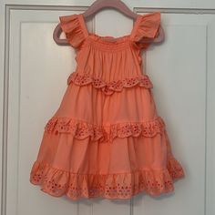 New With Tags! Janie And Jack Baby Girl Eyelet Ruffle Dress. Color Is Peach Amber (Such A Pretty Color). Size 18-24 Months. No Rips, Stains Or Odors. Retail Price: $79. Description From Janie And Jack’s Website: “Warmer Days Are Calling In This Breezy Dress. With A Stretch Smocked Neckline, Ruffle Straps And Tiered Eyelet Details We Love. 100% Cotton Batiste Fully Lined Sleeveless; Button Back Above The Knee Length Bloomer Included (Sizes Up To 18-24m) Machine Washable; Imported” Please See All Pictures And Ask Any Questions. Feel Free To Make Me An Offer Or Bundle With My Other Items For Additional Savings. Thanks For Looking! Cute Sleeveless Tiered Ruffle Dress, Cute Sleeveless Tiered Dress With Ruffles, Playful Ruffle Sleeve Beach Dress, Cute Ruffle Dress With Ruffled Straps For Spring, Sweet Summer Dresses With Ruffles, Playful Sleeveless Ruffle Dress For Spring, Cute Tiered Ruffle Sundress, Spring Dresses With Ruffles For Playdate, Sweet Ruffled Beach Dresses