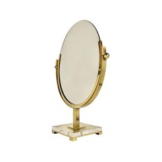 an oval mirror on a stand against a white background