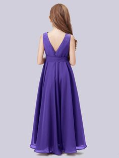 a woman in a purple dress looking down at the back of her head and shoulder