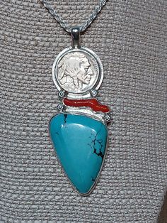 One of a kind, handcrafted, sterling silver pendant with turquoise, red coral, and 1936 Indian head nickel. Measures about 81mm X 30mm. Chain not included. Traditional Turquoise Pendant Necklace, Traditional Sterling Silver Turquoise Necklace Gift, Traditional Turquoise Necklace In Sterling Silver For Gift, Traditional Turquoise Necklace With Large Sterling Silver Pendant, Red Southwestern Turquoise Necklace For Gift, Handmade Turquoise Medallion Necklace Gift, Handmade Turquoise Medallion Necklace As Gift, Handmade Turquoise Medallion Necklace For Gifts, Artisan Rings