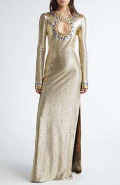 Julien Dossena re-creates the fashion house's signature shine in this gilded gown centered with a circular chest cutout surrounded by dazzling crystal embellishments. 58" length (size 38FR) Back cutout with button-and-loop closure Jewel neck Long sleeves Side slits Unlined 73% viscose, 20% polyester, 7% elastane with 90% cupro, 10% elastane contrast Dry clean Made in Portugal Designer Clothing Luxury Embellished Maxi Length Evening Dress, Fitted Luxury Gown With Rhinestones, Luxury Fitted Gown With Rhinestones, Luxury Gold Gown With Sequins, Luxury Gold Sequin Gown, Luxury Embellished Fitted Maxi Dress, Luxury Festive Maxi Dress For Gala, Luxury Bedazzled Dresses For Formal Occasions, Glamorous Gold Embellished Evening Dress