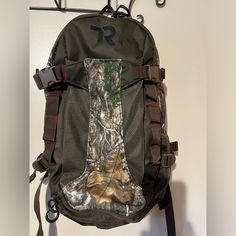 a back pack hanging from a hook on a wall