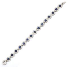 Blue Sapphire and Diamond bracelet in 18K Gold. It has a perfect round cut gemstone to make you stand out on any occasion or an event. A tennis bracelet is an essential piece of jewelry when it comes to your wedding day. The sleek and elegant style complements the attire beautifully, whether it's the bride wearing it herself, or as a gift to her bridesmaids to wear on the D’day.  Bracelets are worn to enhance the look. Women love to look good. It is common to see a woman rocking a lovely gold bracelet on her wrist. A gold gemstone bracelet is the ultimate statement piece for every stylish woman.  PRODUCT DETAILS :-  > Material - 18K Solid White Gold > Gemstone - Blue Sapphire  > Stone Weight - 6.5 ct > Stone Shape - Round  > Stone Pcs - 15 > Stone Size - 4 mm > Diamond Weight - 4.8 ct  > D Luxury Sapphire Diamond Round Bracelet, Luxury Sapphire Diamond Bracelet, Timeless Blue Round Bracelets, Luxury Tennis Bracelet With Halo Setting For Formal Occasions, Luxury Tennis Bracelet With Halo Setting For Formal Events, Sapphire Tennis Bracelet With 17 Jewels, Luxury Formal Bracelet With Halo Setting, Luxury Formal Bracelets With Halo Setting, Classic Sapphire Tennis Bracelet With Round Shape