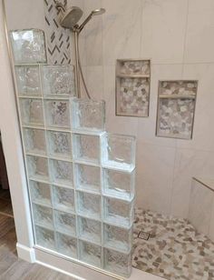 a glass block shower in a bathroom with tile flooring