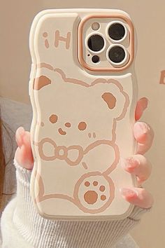 a person holding up a phone case with a bear on it