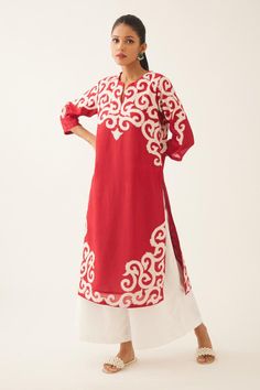 Red silk chanderi straight kurta with cotton applique work at neck, hem and sleeves, highlighted with kantha hand work. Comes with off white cotton wide leg pant with side pockets. 
Components: 2
Pattern: Embroidered
Type Of Work: Trellis Jaal Appliques
Neckline: Notched
Sleeve Type: Three Quarter
Fabric: Silk Chanderi, Pant and Lining- Cotton
Color: Red
Other Details: 
Lined kurta and pant
Side pocketed kurta and pant
Back elasticated pant
Closure: Pant: Front drawstrings
Occasion: Work,Puja - Red Block Print Kurta For Designer Wear, Designer Red Block Print Kurta, Red Block Print Kurta For Transitional Season, Transitional Red Block Print Kurta, Red Block Print Traditional Wear For Navratri, Red Block Print Straight Kurta, Red Straight Kurta With Block Print, Red Chanderi Block Print Sets, Red Cotton Palazzo Set With Traditional Drape