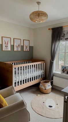 a baby's room with a crib, rocking chair and pictures on the wall