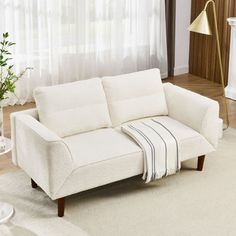 a living room with a white couch and coffee table