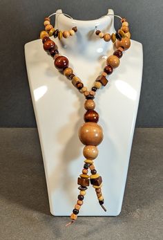 With the look of the 70's returning, I decided to create jewelry like the one I had back then. Beads range in size from 1/4" up to 1" and are in hues from tan to dark brown.  The necklace hangs down about 19". Also includes a pair of wire and beaded Earrings. Comes in a gift bag. Wood Beads Jewelry, Diy Necklaces, Wood Bead Necklace, Necklace And Earring Set, Bead Jewelry, Raleigh Nc, Wood Jewellery, Beaded Jewelry Diy, Beads Jewelry