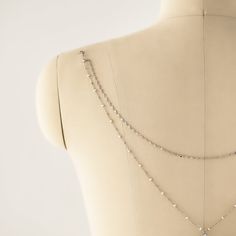 The ultimate backdrop jewelry for a V-shape low back dress! This delicate Pearl Y Lariat Cubic Zirconia chain back jewelry is the perfect accessory. Easy to wear, clips onto your dress. .925 Sterling Silver Freshwater Pearls, 3mm Cubic Zirconia Crystals, 5mm + 7mm Hypoallergenic, lead and nickel free Back Length 12 in (30 cm) Note:You must attach loops to dress in order to clip back jewelry #NBC084 2-3 business days Backdrop Jewelry, Pearl Back Necklace, Backdrop Necklace Wedding, Backdrop Necklace, Low Back Dress, Backdrops Necklace, Low Back Dresses, Back Necklace, Back Jewelry