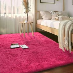 a bedroom with a pink rug on the floor