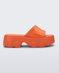 Side view of a orange Ella Slide platform Trendy Jelly Sandals With Rubber Sole For Summer, Summer Clogs With Translucent Outsole, Bold Synthetic Platform Sandals, Trendy Summer Jelly Sandals With Rubber Sole, Casual Synthetic Sandals With Lug Sole, Bold Platform Sandals For Spring, Bold Spring Platform Sandals, Casual Sandals With Chunky Platform And Open Heel, Modern Chunky Platform Sandals For The Beach