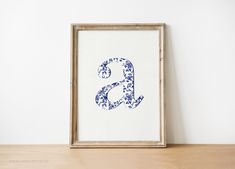 the letter b is made up of blue and white flowers on it's frame