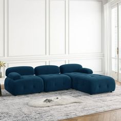 a large blue couch sitting on top of a rug