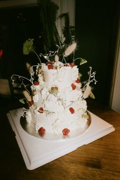 a large white cake sitting on top of a wooden table