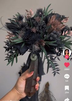 a person holding a vase with flowers in it and an instagram on the screen