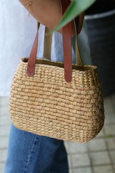 Crafted with love by skilled Vietnamese artisans, this exquisite handbag is a perfect blend of tradition and modern style. Made from sustainably sourced water hyacinth and detailed with soft, durable cotton, this handbag showcases the beauty of natural materials and the artistry of local craftsmanship. KEY FEATURES:  Bag mouth : 19cm/7.5 inches Length : 25cm/9.8 inches Width : 9cm/3.5 inches Height : 20cm/ 7.8 inches Material: Water Hyacinth, Leather Handwoven with Care: Each handbag is meticulously handwoven using water hyacinth, a natural material known for its strength and unique texture. The intricate weaving process reflects the dedication and skill of our artisans. Delicate Cotton Details: The cotton accents add a soft touch, enhancing the overall design and providing a beautiful con Eco-friendly Bucket Bag With Braided Handles, Eco-friendly Shoulder Bag With Braided Handles For Daily Use, Eco-friendly Natural Color Shoulder Bag For Everyday Use, Eco-friendly Natural Shoulder Bag For Everyday Use, Eco-friendly Woven Shoulder Bag With Double Handles, Natural Woven Satchel Shoulder Bag, Daily Use Shoulder Bag With Woven Natural Fiber, Eco-friendly Natural Bag With Braided Handles, Natural Woven Beach Bag For Daily Use