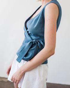 "Fitted, aesthetic, and very elegant sleeveless linen wrap top made from Lithuanian washed linen fabric. Comes with a belt to tie on the side for an effortless but well put together look. FABRIC: 100% Washed Lithuanian Linen COLOR: Please choose the desired color from the side menu. STYLE: Fitted linen sleeveless wrap top with a belt tied on the side. SIZE CHART: 2 US/ 6 AU/ 34 EU: Bust 31.5\" (80 cm) , Waist 23\" (59 cm), Hips 35\" (88 cm) 4 US/ 8 AU/ 36 EU: Bust 33\" (84 cm) , Waist 25\" (63,5 Blue Linen V-neck Blouse, Cotton Wrap Top For Summer, Fitted Wrap Top For Summer, Casual Linen Wrap Top For Summer, Casual Linen Wrap Top, Summer Cotton V-neck Wrap Top, Fitted Sleeveless Wrap Top For Spring, Fitted Sleeveless Wrap Top Casual, Casual Cotton Wrap Top