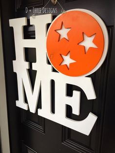 a door sign that says home with stars on the top and bottom half of it