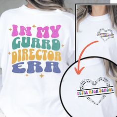 a woman wearing a white shirt with the words in my guard director err on it