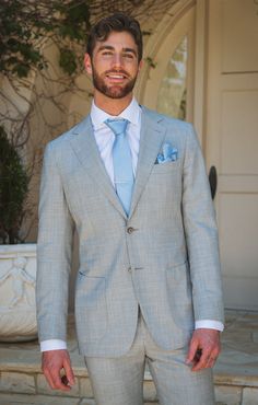 a man in a gray suit and blue tie