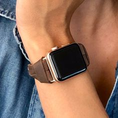 a person wearing a leather apple watch band