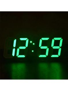 a digital clock with green numbers is shown in the dark, and it appears to be half - lit