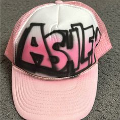 Ashley Airbrushed Name Sun Cap Trucker Hat Adjustable Strapback Pink Pink 5-panel Snapback Hat For Streetwear, Pink Hip Hop Hats For Streetwear, Pink Snapback Hat For Streetwear With Flat Brim, White Hip Hop Trucker Hat With Letter Print, Pink Flat Brim Trucker Hat For Streetwear, White Trucker Hat For Summer Streetwear, Hip Hop Style White Baseball Cap, White Hip Hop Snapback Hat With Letter Print, White Hip Hop Baseball Cap, One Size Fits Most