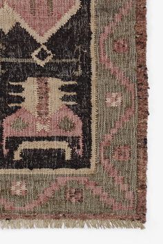 an old rug with a cat design on the front and back side, in pink tones