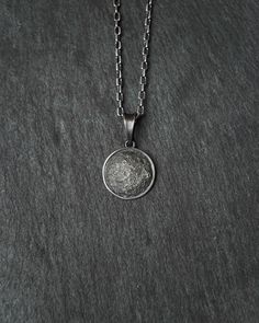 Full Moon silver pendant Metal: Sterling Silver 925 The pendant measures: 16,7 x 16,7 mm Crafted from sterling silver, this exquisite pendant beautifully captures the allure of the full moon. The intricate details highlight the lunar surface, reflecting its celestial charm. Adorn your neckline with this stunning piece, a tribute to the mystique and elegance of the moon's ethereal beauty. Elegant Silver Moon-shaped Jewelry, Elegant Silver Moon Jewelry, Sterling Silver Sphere-shaped Jewelry, Sterling Silver Round Disc Coin Pendant, Sterling Silver Medallion With Moon Charm, Sterling Silver Moon Charm Medallion Jewelry, Silver Moon Phase Amulet Jewelry, Celestial Necklaces With Polished Round Pendant, Sterling Silver Moon Charm Pendant