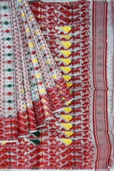 White resham soft Jamdani handloom cotton Silk with woven red border and all over multicoloured floral butta. Traditional designed jamdani saree with a rich look. Teams up well with traditional earrings. Stitching facility for falls-zigzag available on request, free of cost.  Dimensions - 5.5m saree length in handloom Jamdani weave. No blouse piece. Best quality Transitional White Traditional Wear With Woven Motifs, White Dupatta With Woven Motifs For Transitional Season, Transitional White Dupatta With Woven Motifs, Multicolor Cotton Saree With Weaving Work, Multicolor Cotton Saree With Weaving Details, Handloom Multicolor Embroidered Cotton Dupatta, Handloom Cotton Dupatta With Multicolor Embroidery, Multicolor Saree With Weaving Work, White Saree With Woven Motifs For Festivals