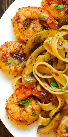 pasta with shrimp and peppers on a white plate